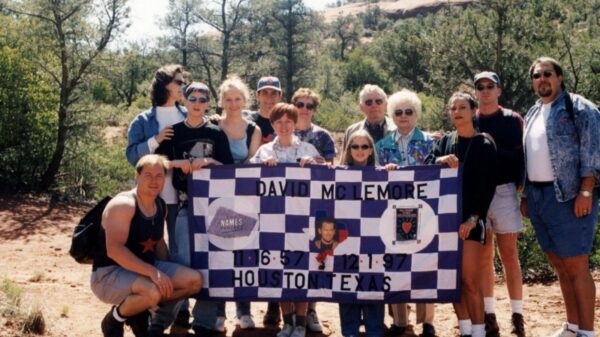 Group of people posing outdoors holding a memorial banner for David McLemore in Houston, Texas