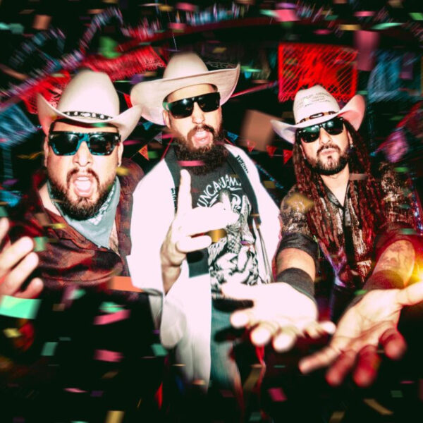 Three men in cowboy hats and sunglasses pose toward the camera while confetti falls around them at a lively party?performance vibe.