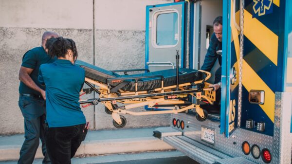 ems - Austin Latino Paramedics load a patient stretcher into an ambulance to transport.