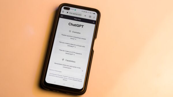 Phone screen showing ChatGPT interface with Examples and Capabilities sections open on a peach background