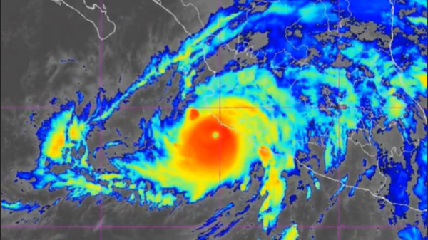 Tropical cyclone with a distinct eye, bright red center and surrounding yellow and blue rain bands on a satellite radar map.