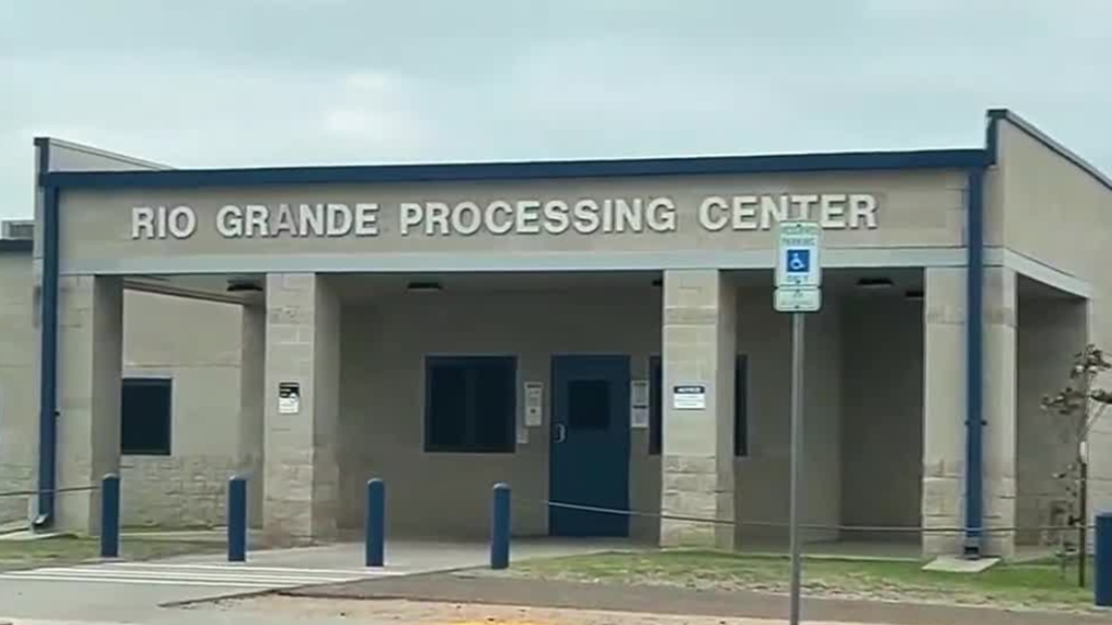 Front view of a building labeled Rio Grande Processing Center with blue doors and columns.