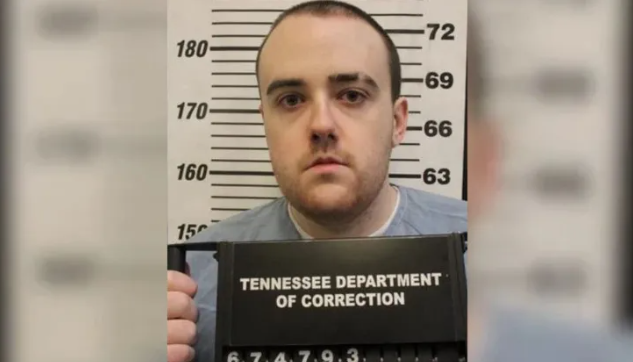 Mugshot portrait of a man in a gray shirt in front of a height measurement board, holding a Tennessee Department of Correction sign below.